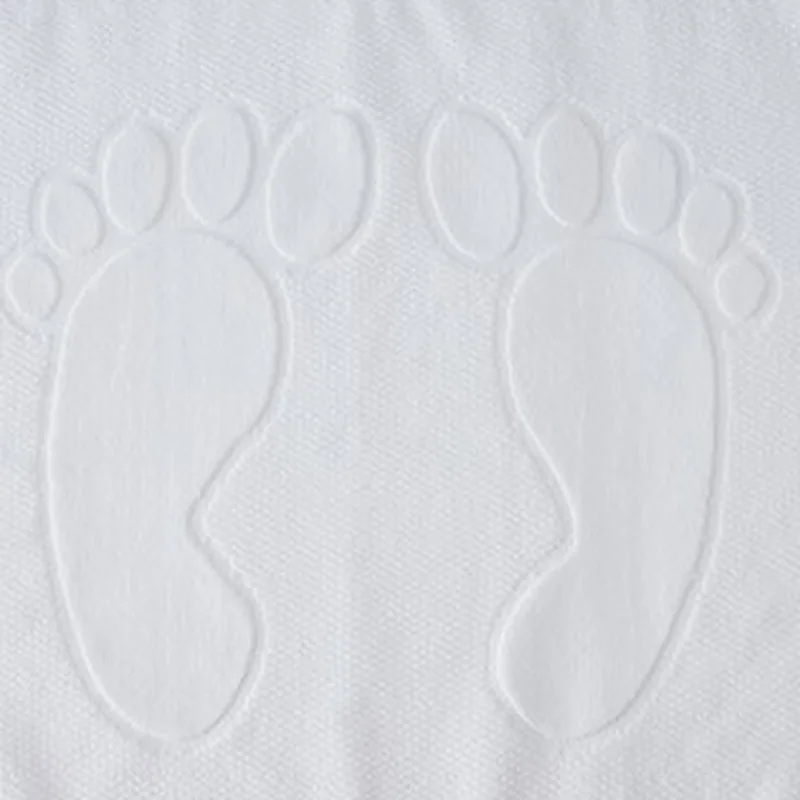 White terry bath mat with embossed footprint pattern