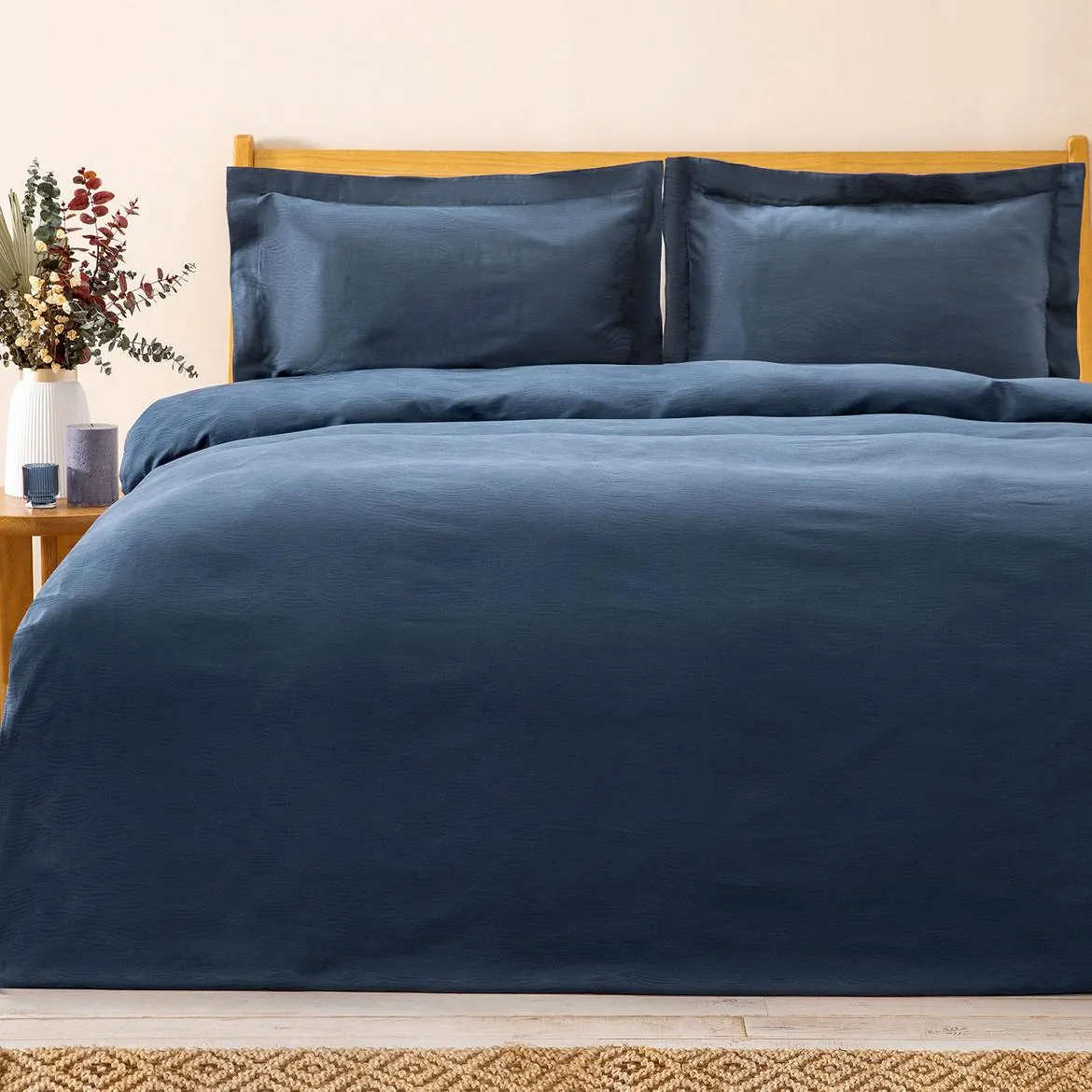 Bed dressed in a navy duvet cover set