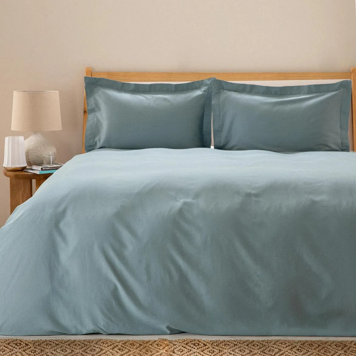 Bed dressed in a mint green duvet cover set