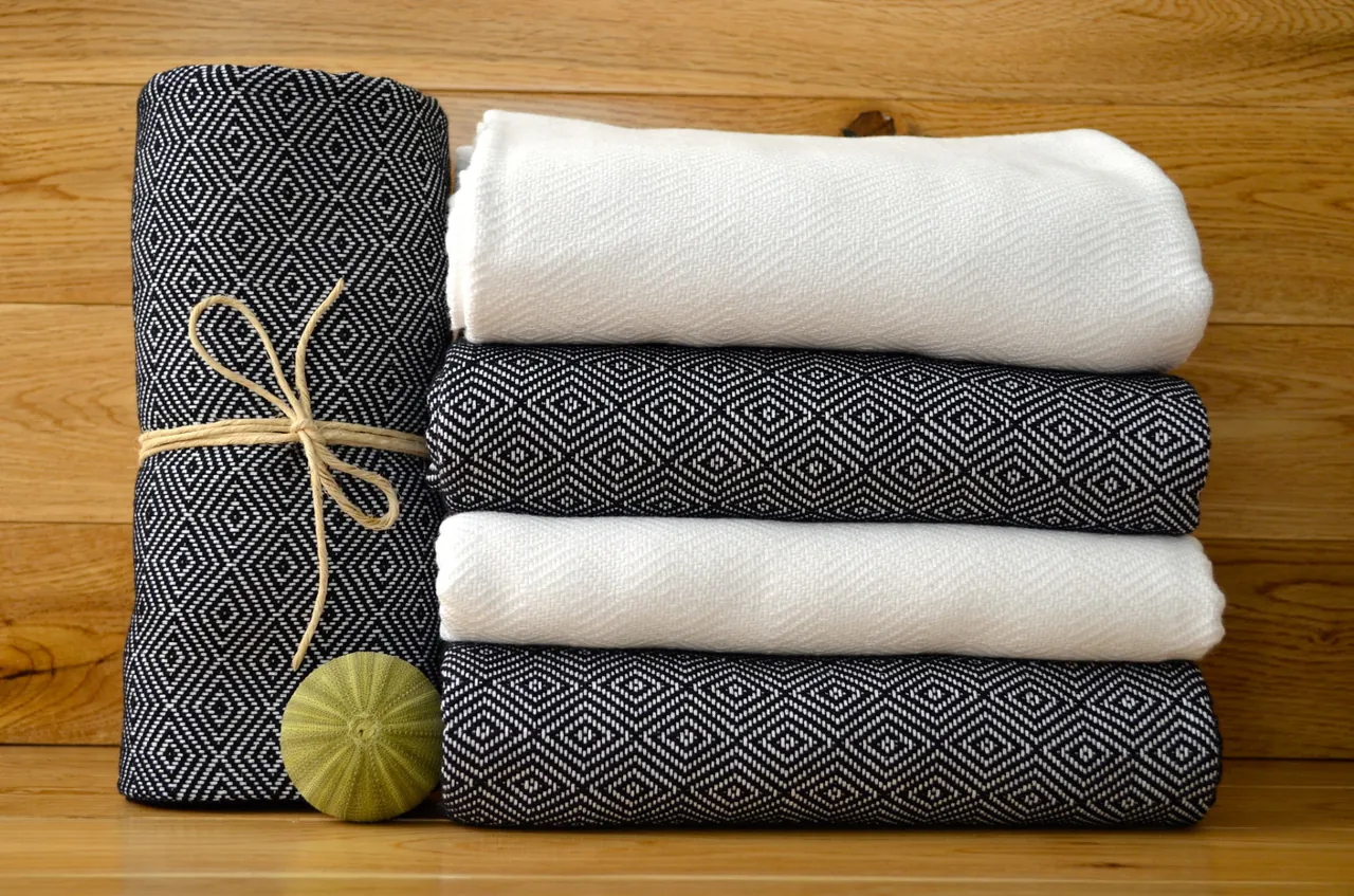 Folded peshtemals in navy diamond weave and plain white, tied with string